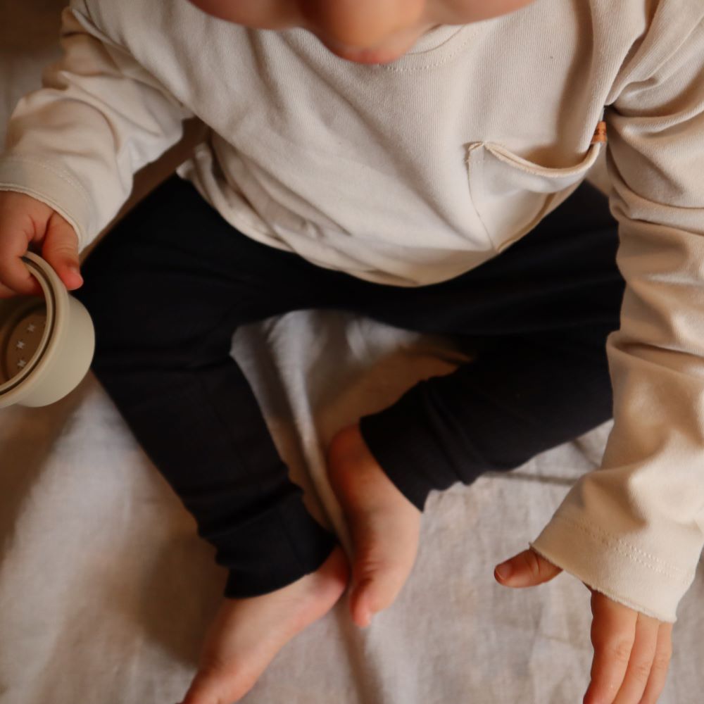 Longsleeve dust voor baby's (kinderen) met een zakje aan de voorzijde van het merk Nixnut.